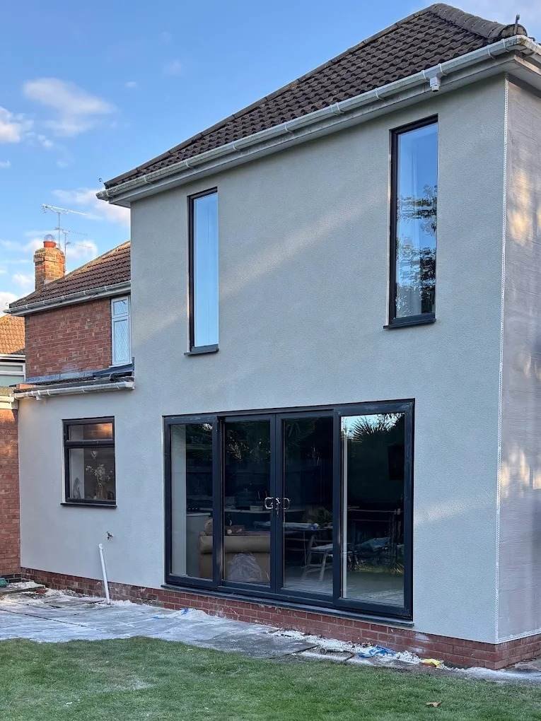Rear extension in Cottingham with grey bifold doors and crisp silicone render by Neil Spence